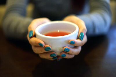 Image of hand holding a seaming reacup