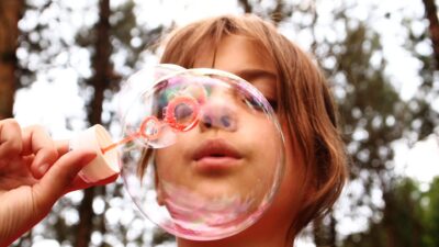 Child plowing bubbles