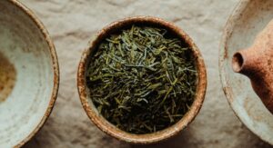 Image of cup fll of shredded herbs next to other empty bowls