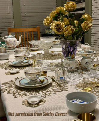 Image of table with place setting and gold placemats.