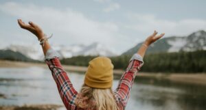 image of happy woman with arms up