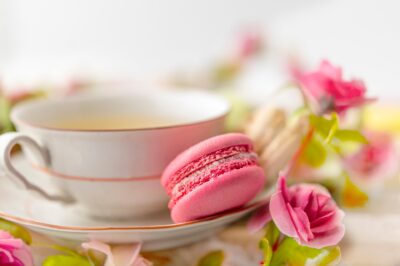 Image of one teacup with cookies and flowers